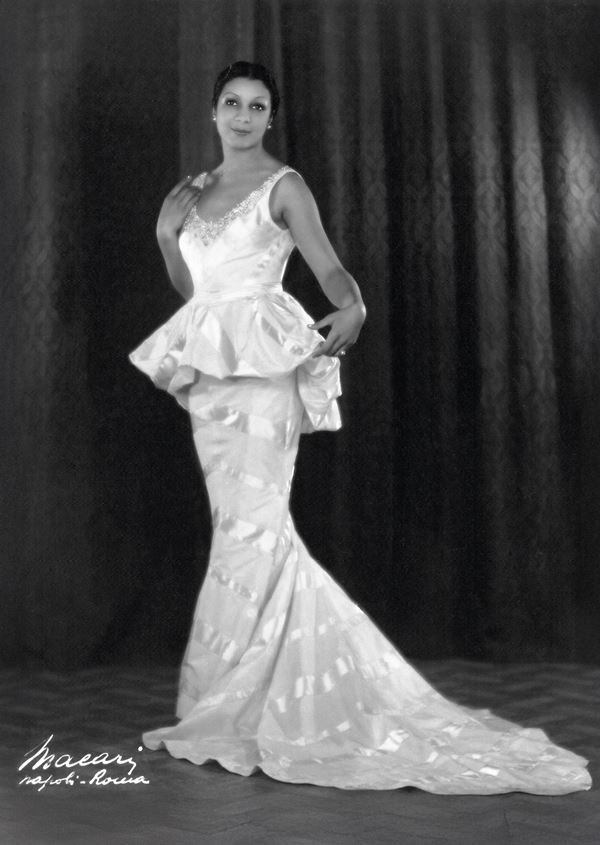 black and white photo of elegant black woman in an elaborate evening dress